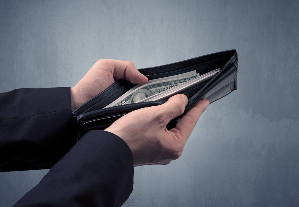 Businessmans hand in suit takes out dollar money from a wallet-1