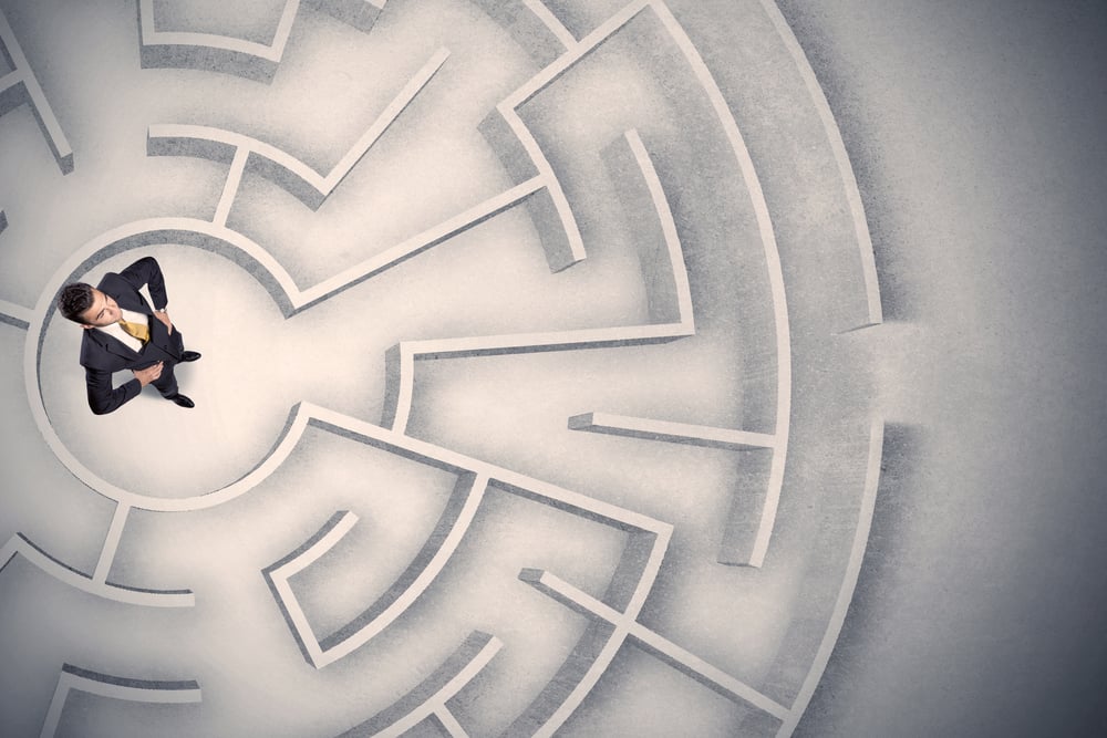 Confused business man trapped in a circular maze