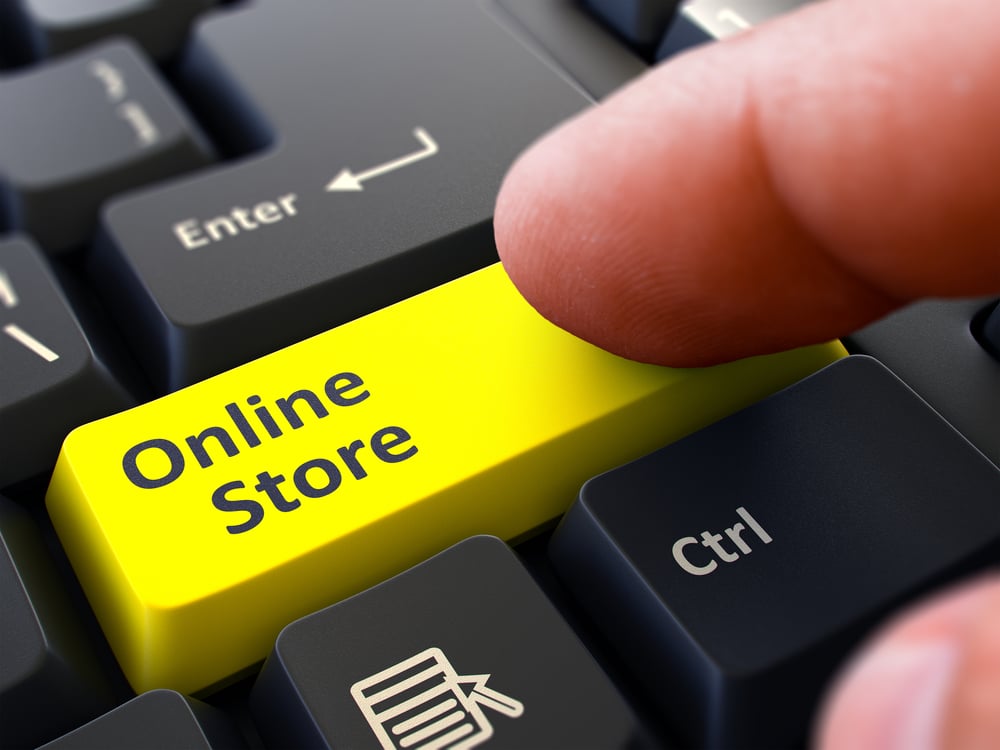 One Finger Presses Yellow Button Online Store on Black Computer Keyboard. Closeup View. Selective Focus.
