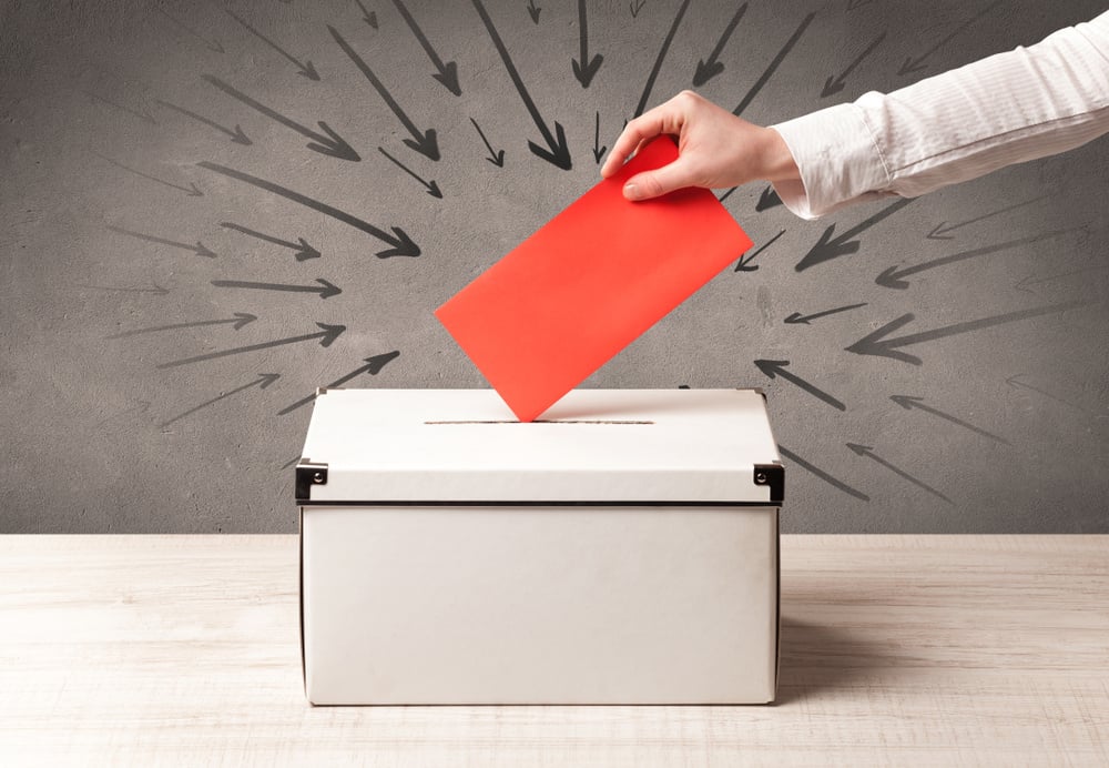 close up of a ballot box and casting vote on grungy background