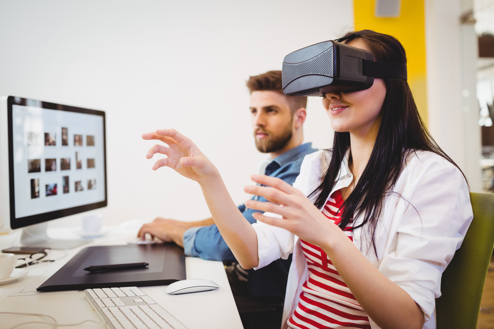 Young female executive enjoying augmented reality headset at creative office
