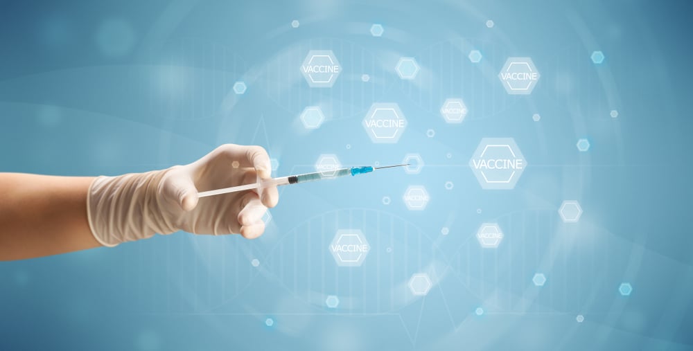 Female doctor hand holding syringe with blue background