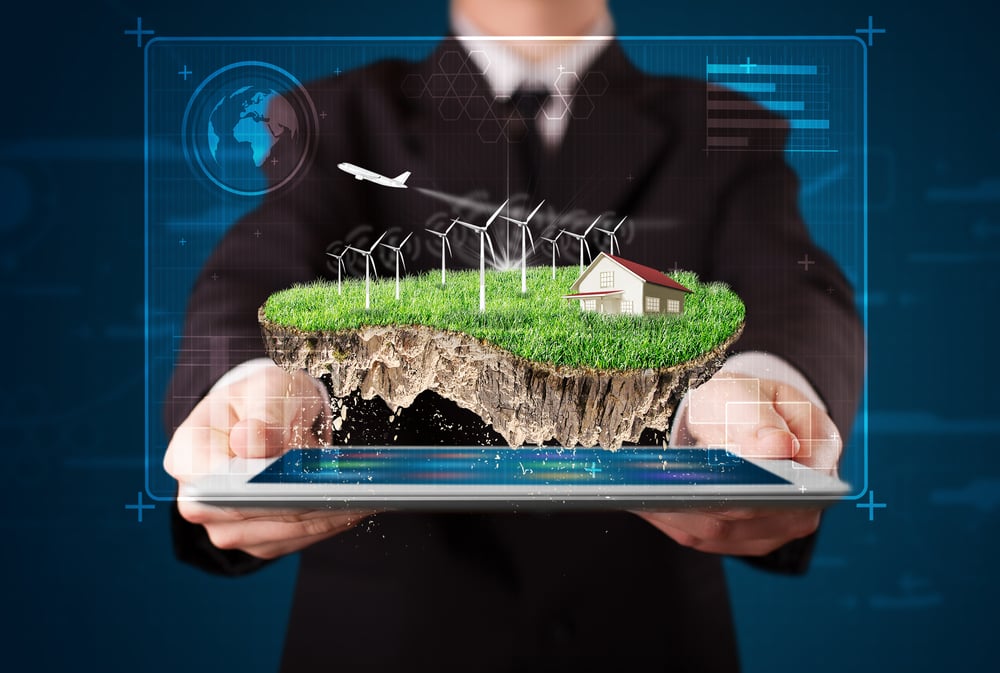 Young businessman presenting a perfect ecology land with a house and windmills